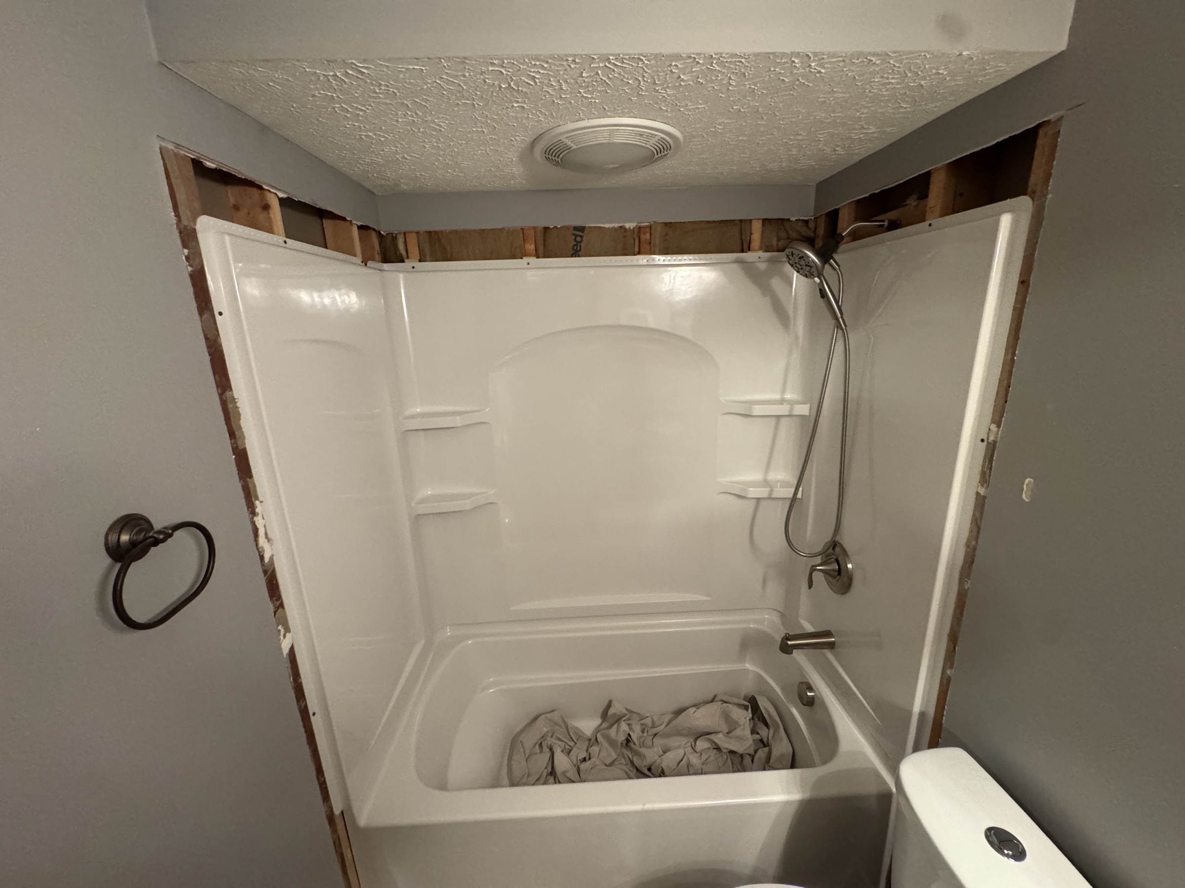 Bathroom with unfinished wall surfaces before painting