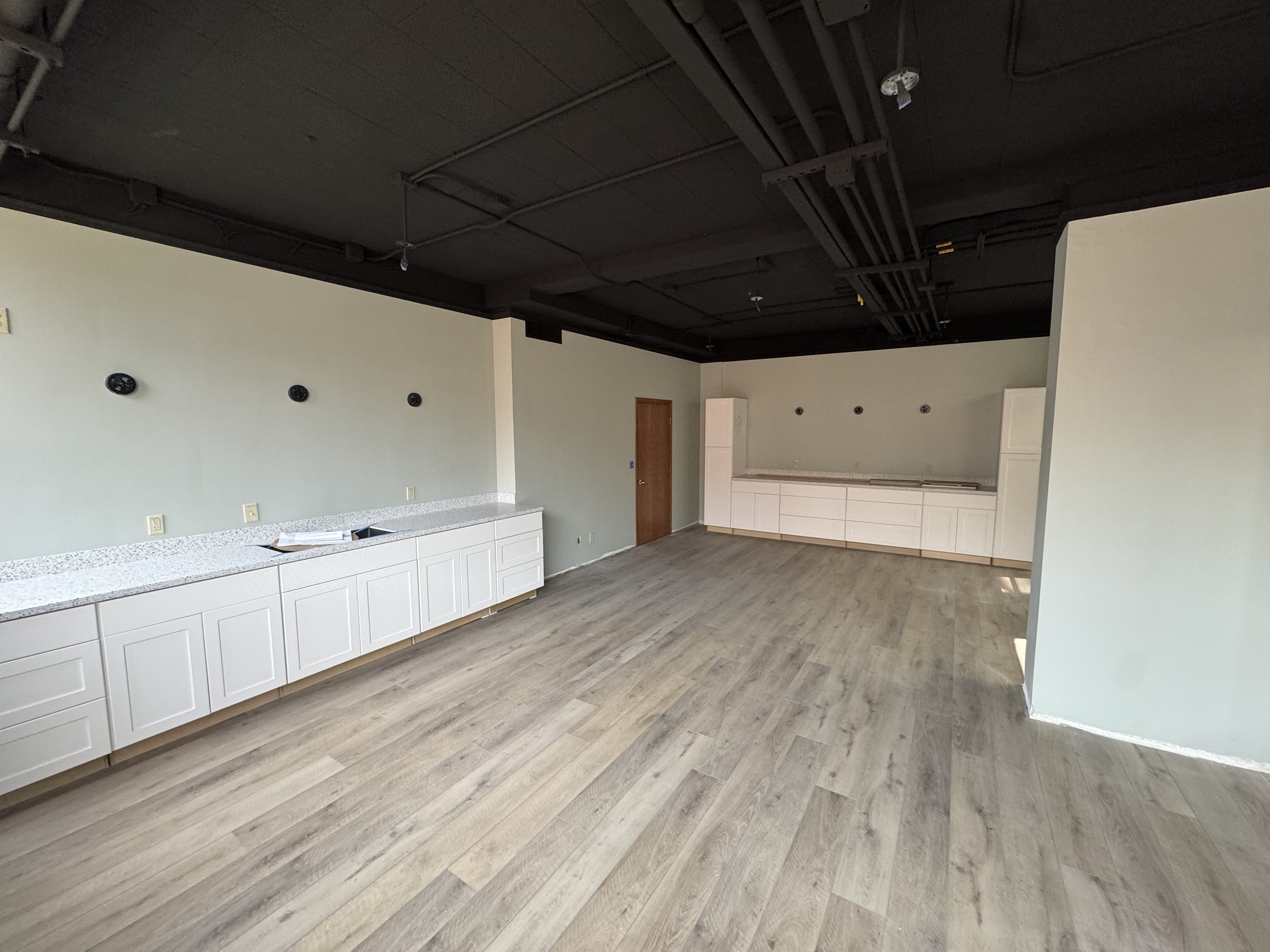 Completed commercial interior with painted walls, ceiling, and cabinetry